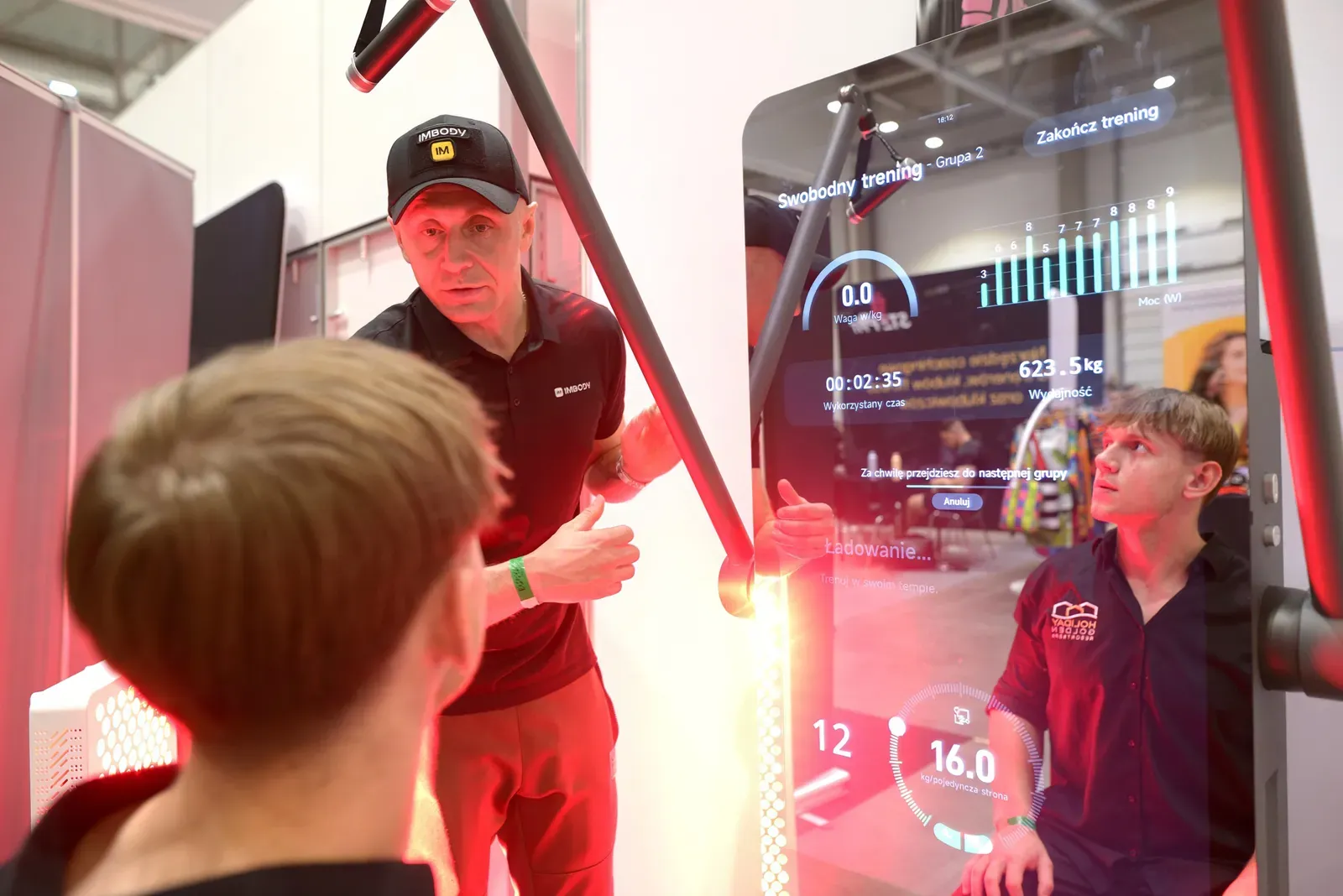 Exhibitor demonstrating equipment to visitors on the expo floor
